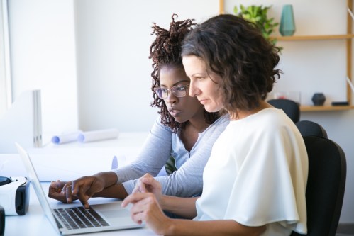 Female colleagues watching presentation